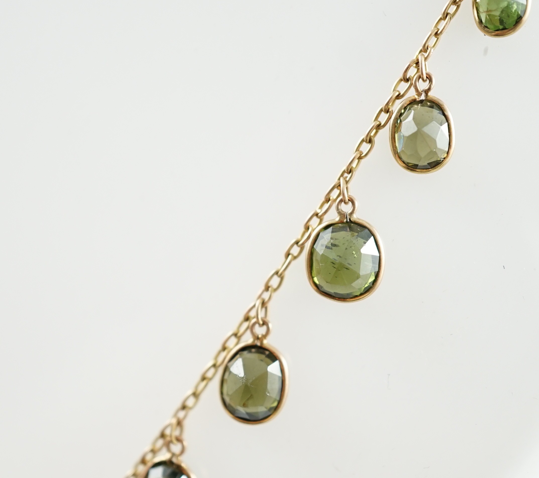 A late Victorian 15ct gold and graduated oval cut green tourmaline fringe choker necklace